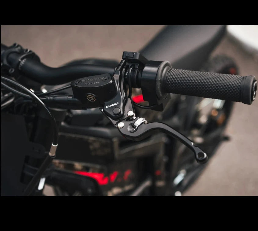 Close-up of a motorcycle handlebar assembly with a black brake lever, brake master cylinder