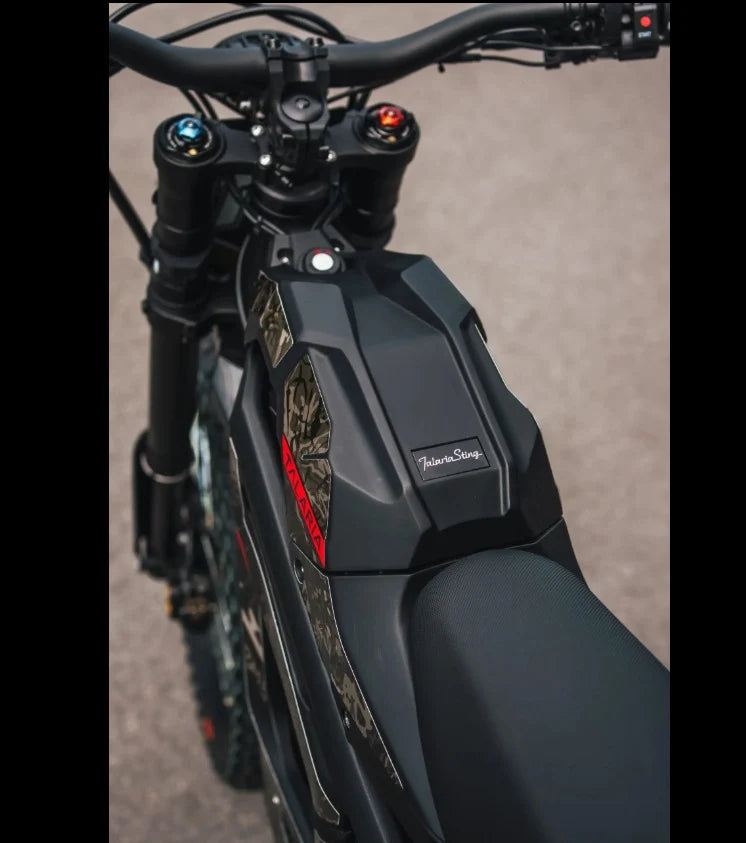 Close-up of a black Talaria Sting MX5 electric dirt bike showing the handlebars and front suspension fork