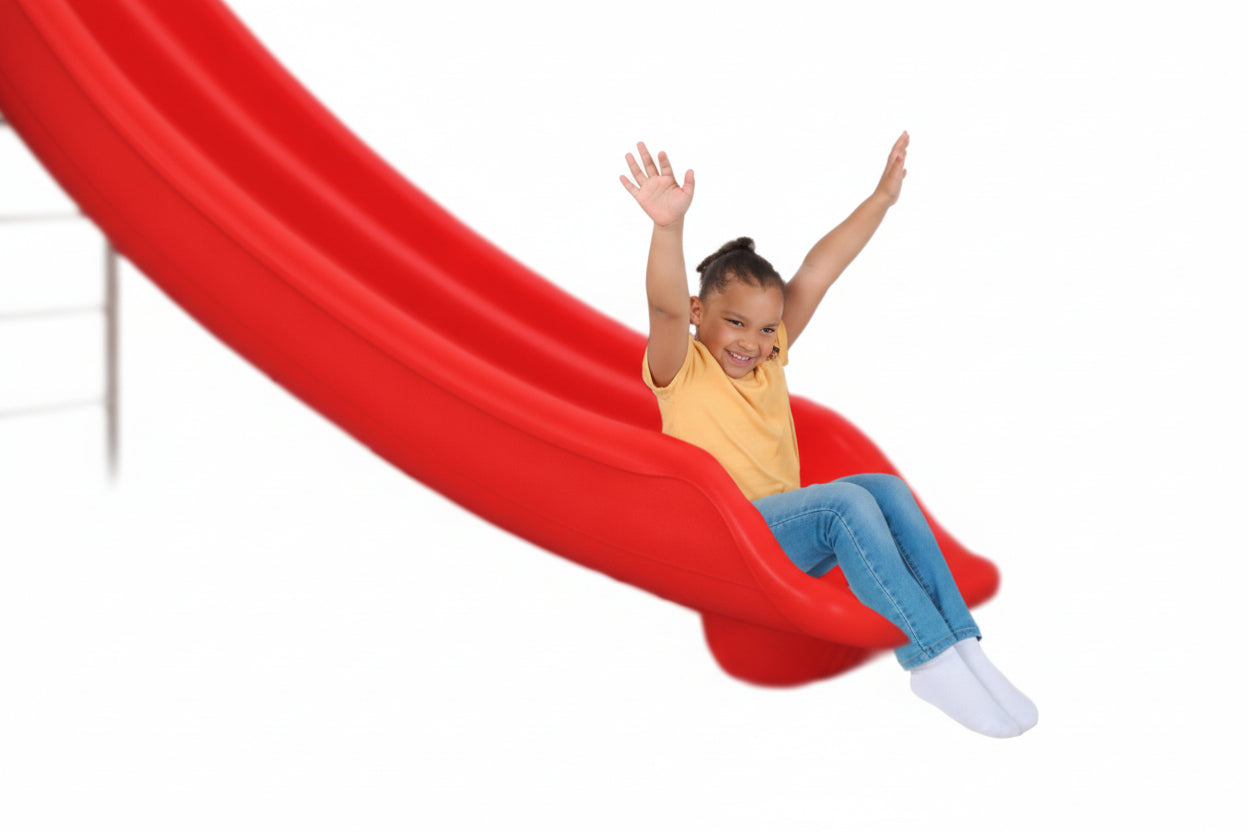 Child sliding down a red slide