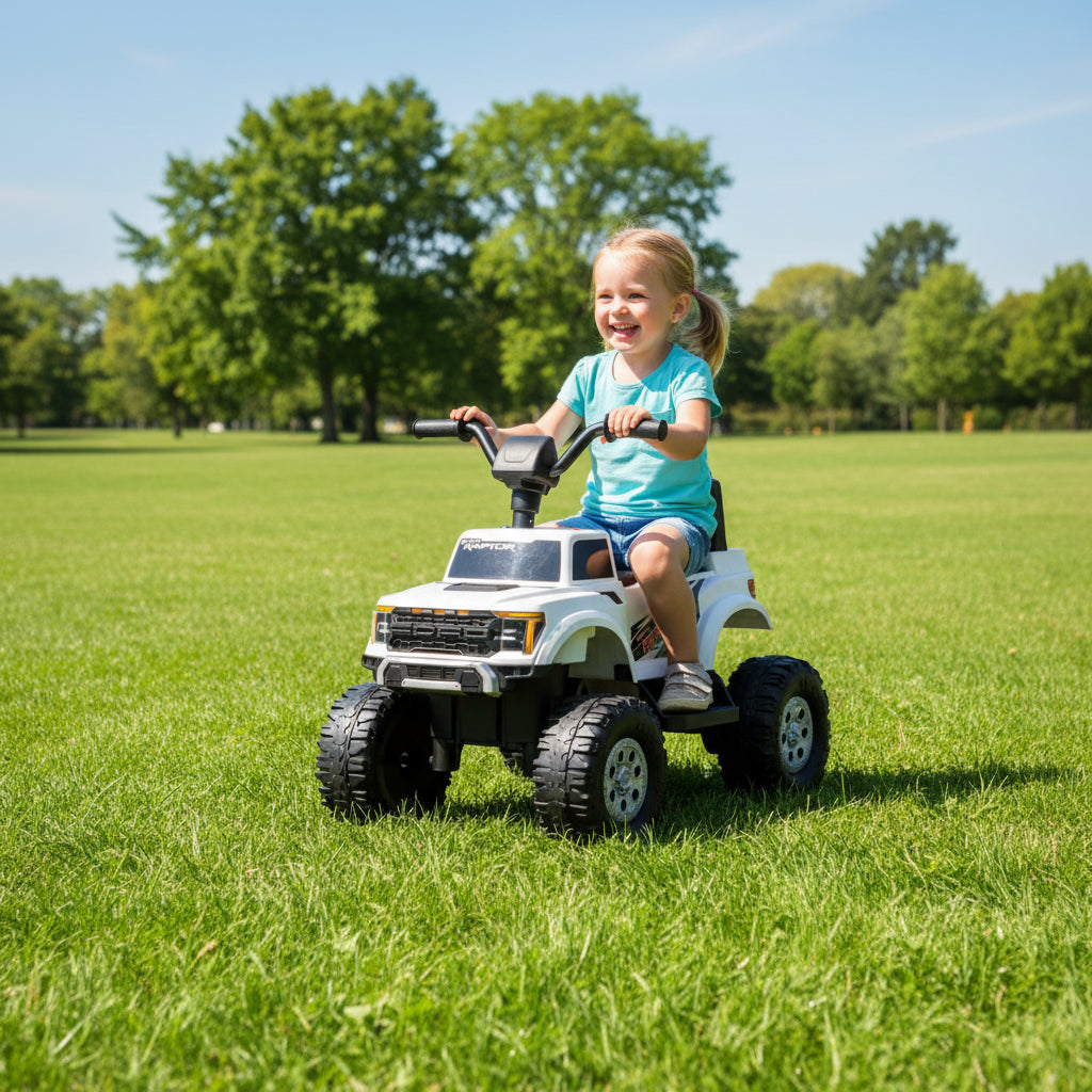 Child riding a toy truck in a grassy field 