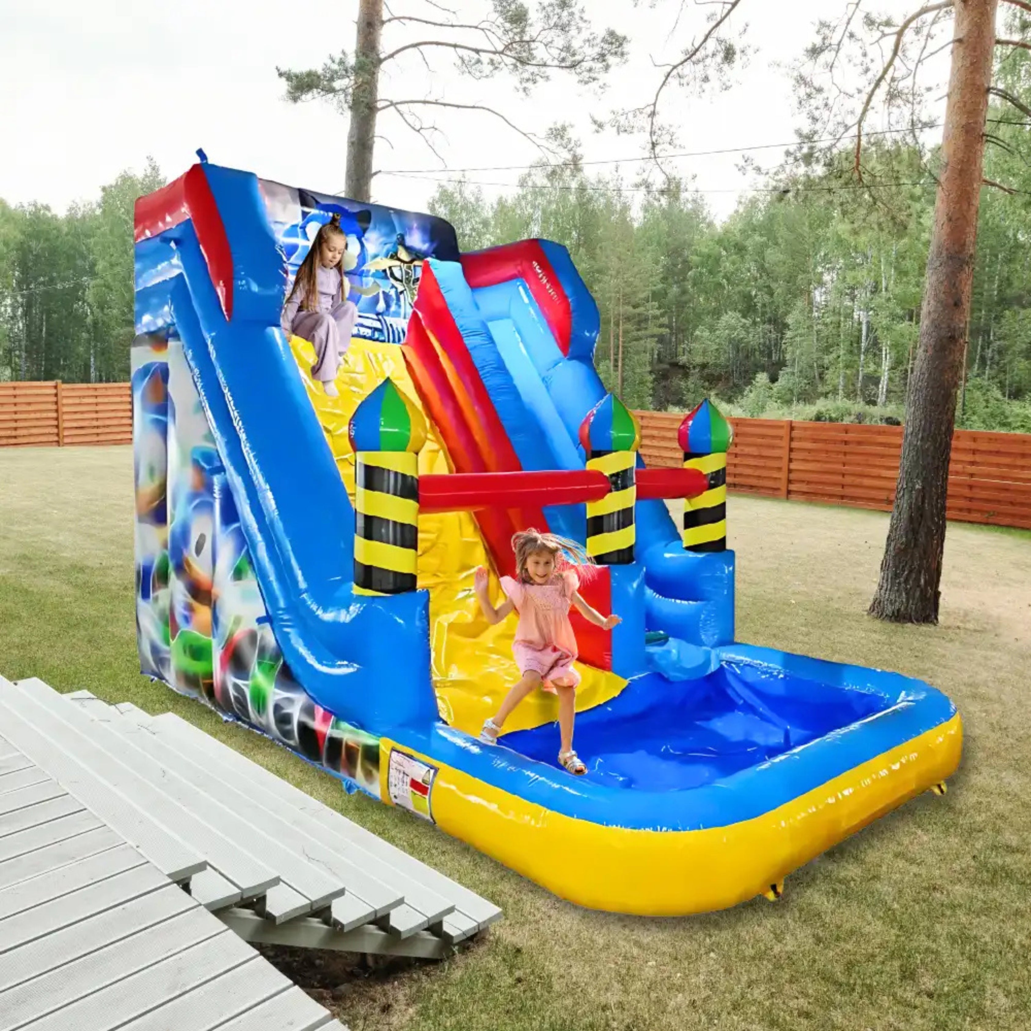 Colorful inflatable water slide with a pool in an outdoor setting