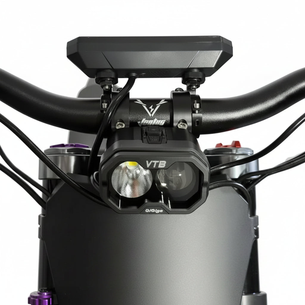 A close-up of a black Jengking VTB front light mounted on an off-road dirt bike handlebar