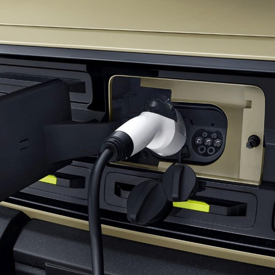 An electric charging cable is plugged into an Ecar's charging port