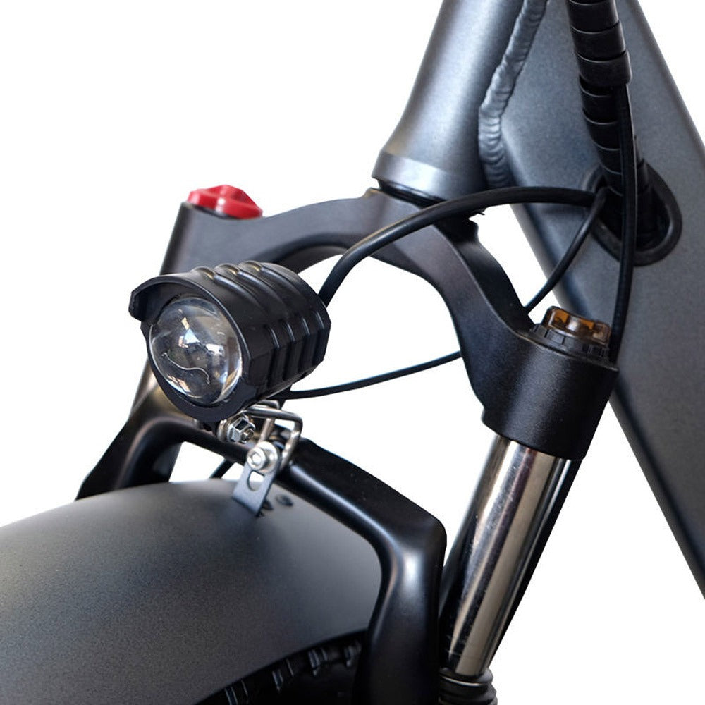 Close-up of a motorcycle headlight and handlebars