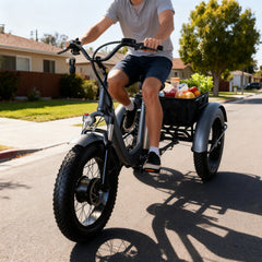 A person riding a three-wheeled electric bike with a cargo box