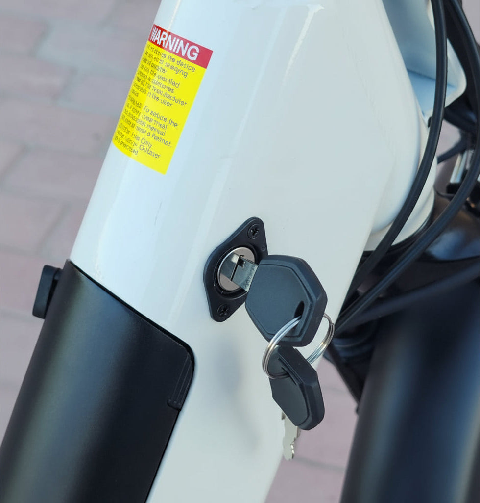 Close-up of a motorcycle key ignition with a warning label