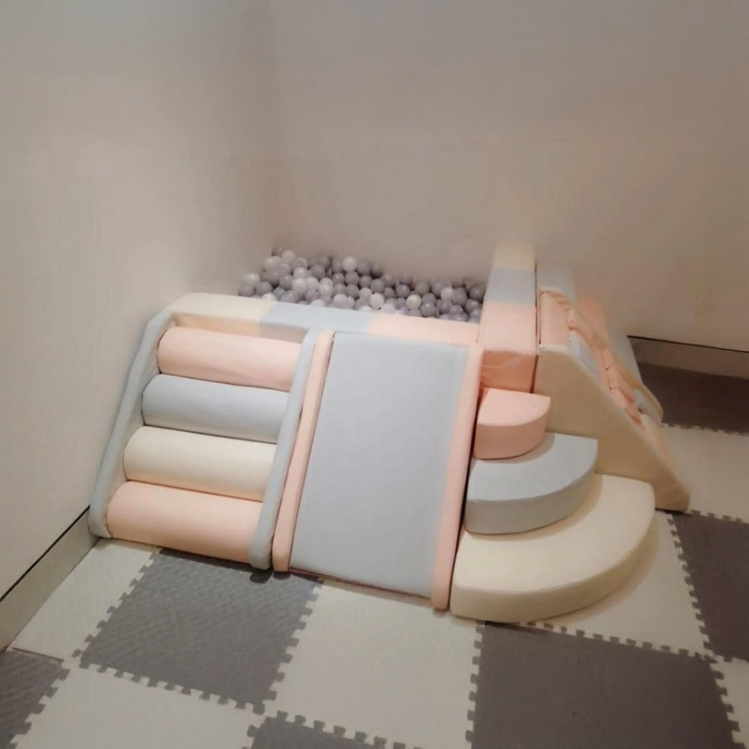 Soft-play zone for toddlers with climbing blocks and a foam-ball pit floor