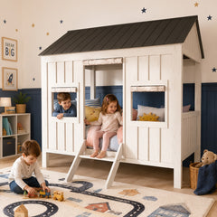 A kids' house-shaped Wooden bed in a styled bedroom, with kids playing on and around the bed