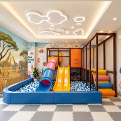 A colourful kids' indoor commercial  playground with a ball pit, dual slides, and animal-and-ocean murals
