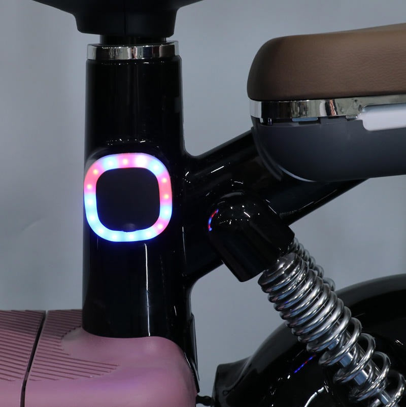 Close-up of a Scooter handlebar with a colourful light 