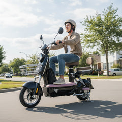 Person riding an electric scooter on a suburban street