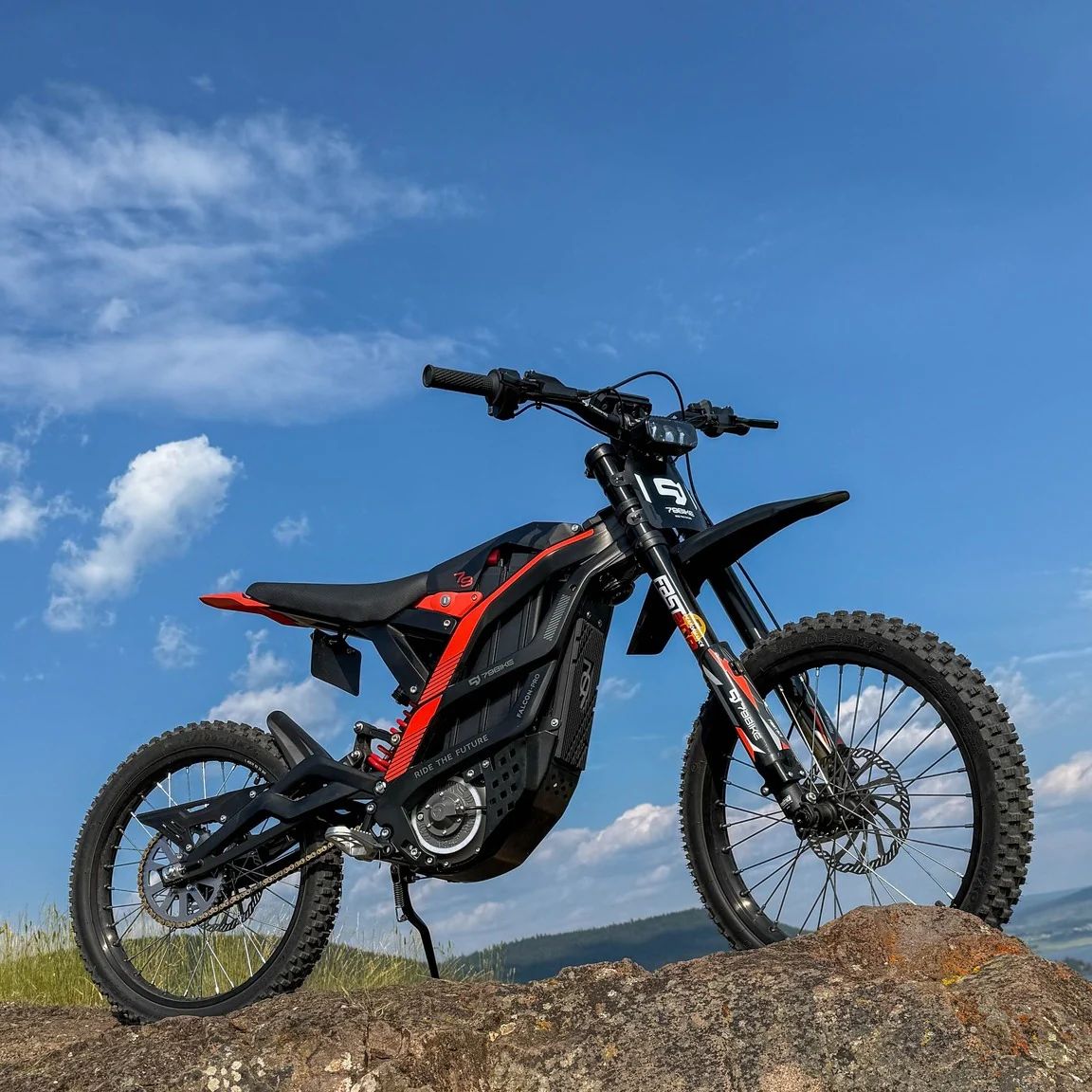 Black and red 79BIKE-Falcon Pro Electric Dirt Bike on a rocky outcrop 