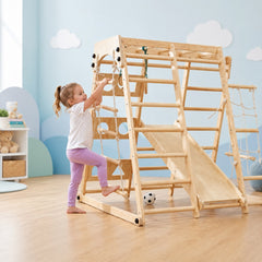 Child playing on a wooden climbing structure in a room