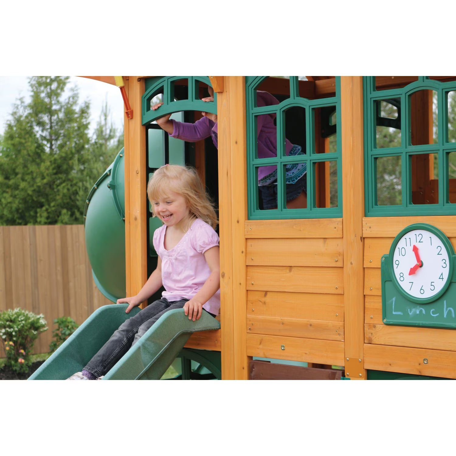 KidKraft Charleston Lodge Fort, Children playing on a wooden slide
playhouse with a slide and clock.