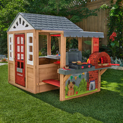 Wooden playhouse with kitchen and pizza oven grill in garden