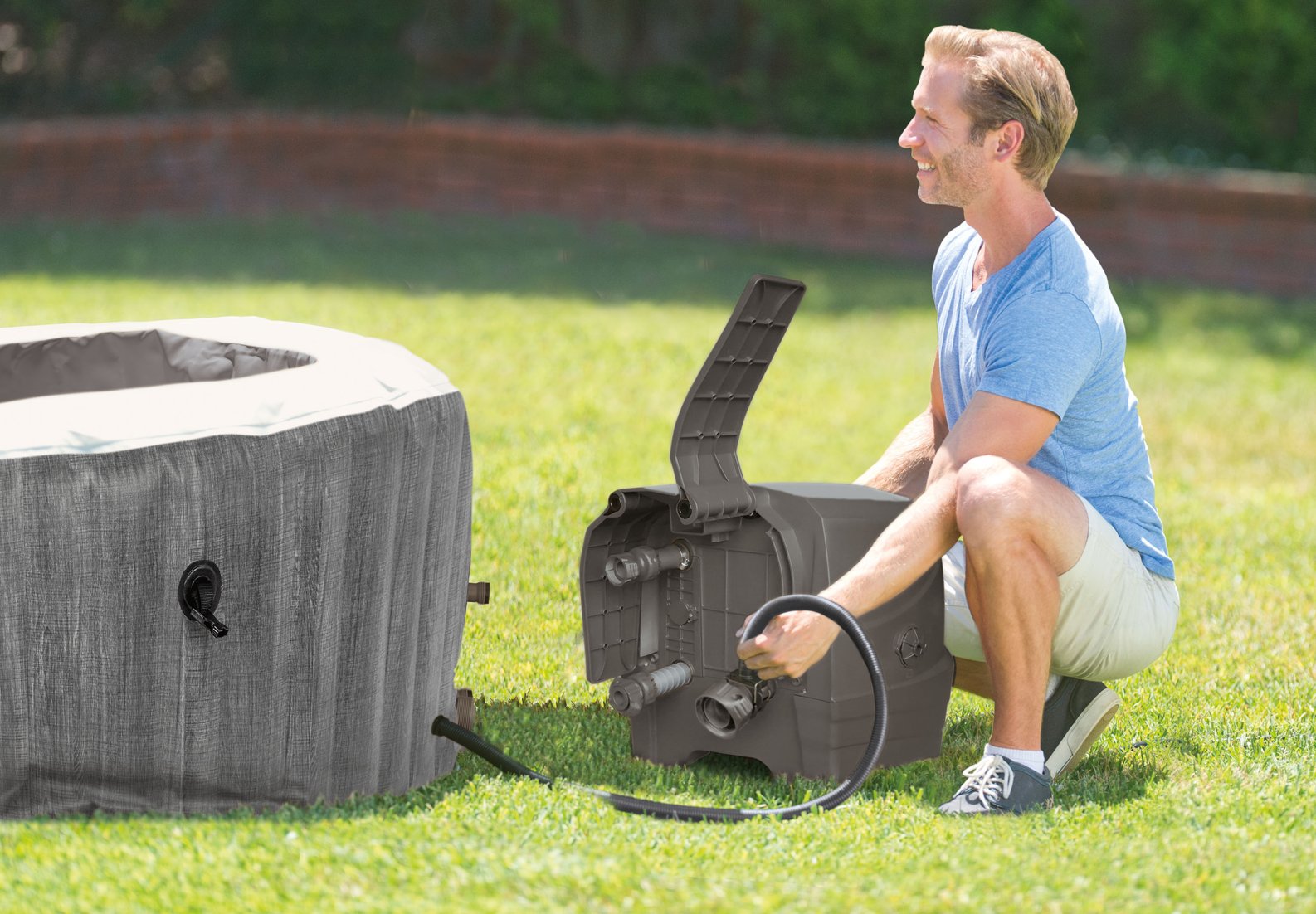 Man inflating an inflatable hot tub 