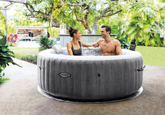 A couple in an inflatable hot tub outdoors