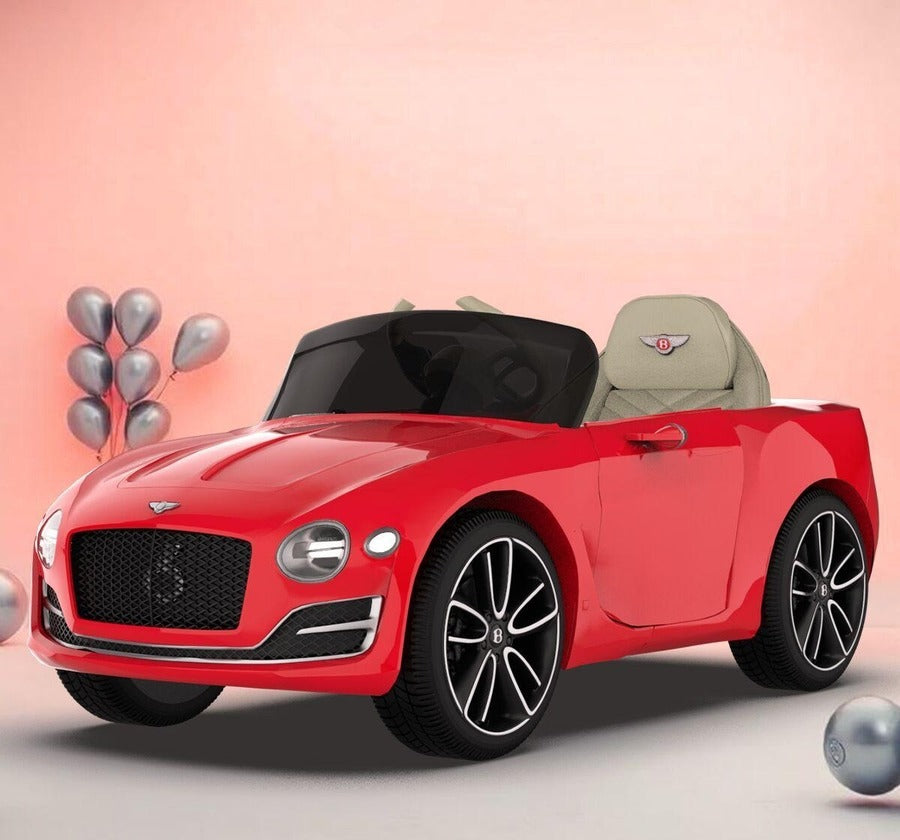 Red toy Bentley car on a light pink background with balloons.