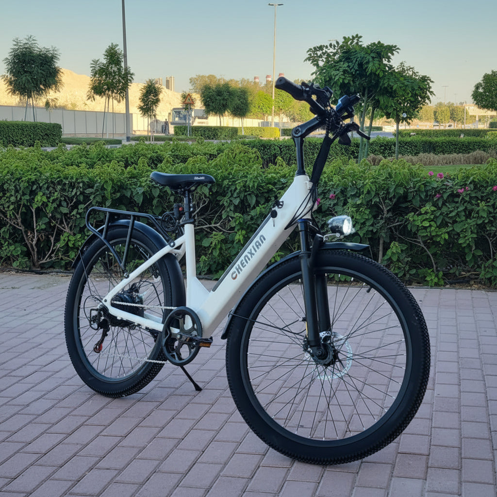 White electric bike on a paved path with greenery 
