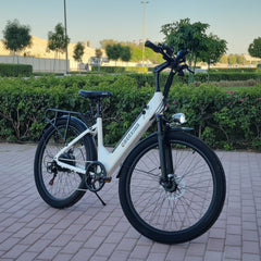 White electric bike on a paved path with greenery 