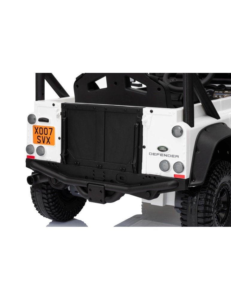 Back view of a white Land Rover Defender with a black bumper