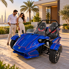 electric Roadster Trike vehicle is parked outside a modern villa with two people standing nearby.