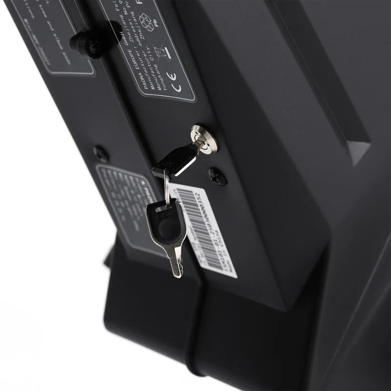 Close-up of a black electronic device with labels and connectors