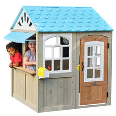 Children playing in a Kidkraft Oceanfront Wooden Outdoor Playhouse